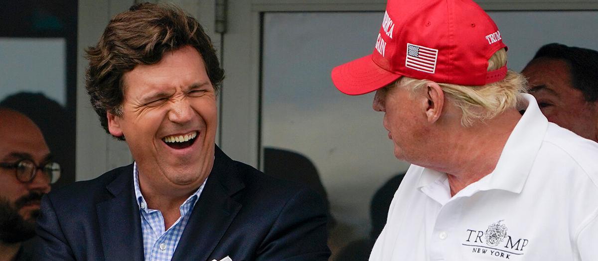 Tucker Carlson, till vänster, och tidigare president Donald Trump tillsammans på en bild från en golfturnering i juli förra året. Foto: TT